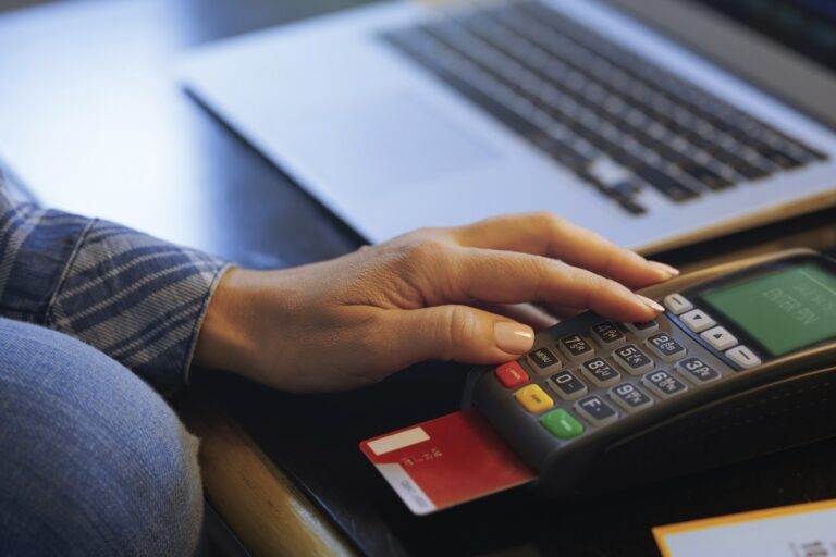 Woman with laptop using online banking, close-up